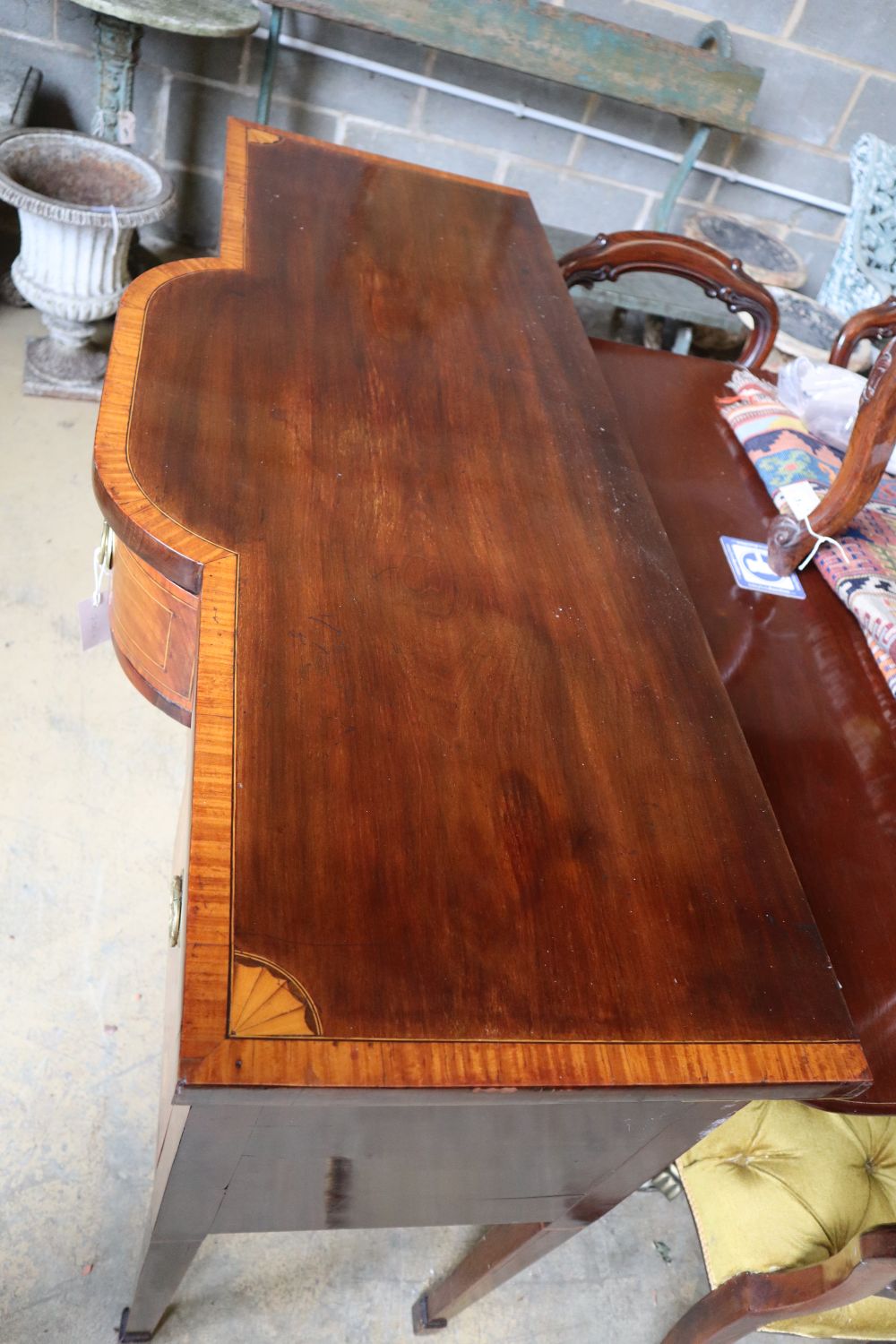 A George III satinwood banded and inlaid mahogany bowfront sideboard, width 129cm depth 53cm height 91cm